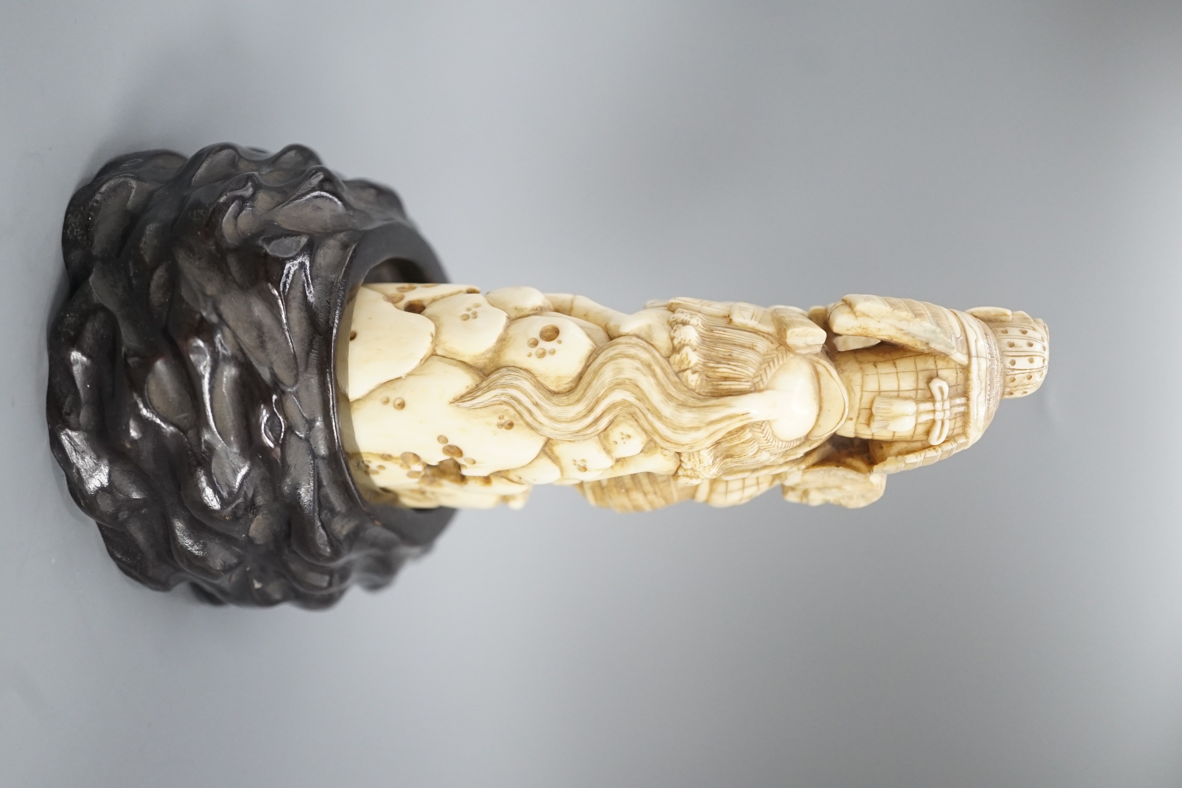 A Japanese ivory okimono of a samurai on horseback, with an attendant behind him, signed, late 19th century 12cm